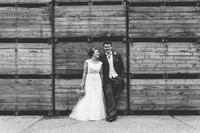 bride and groom at their farm wedding in kent posing for their kent wedding photography