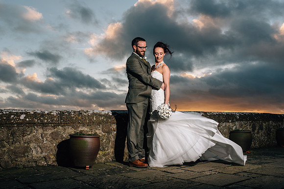 Bride and groom posing at their wedding held at Lympne Castle for their Kent wedding photographer