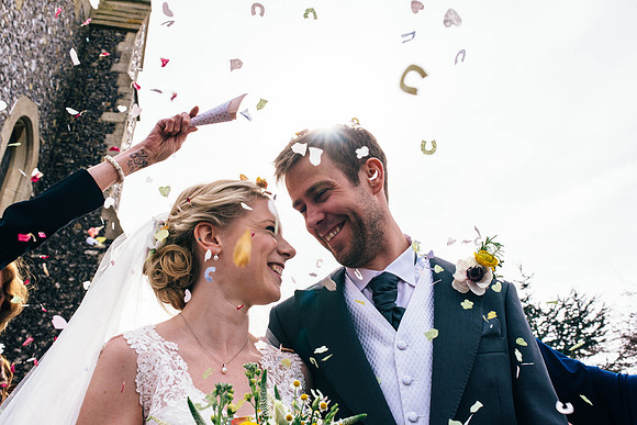 Bride and groom confetti shot during their wedding at Swarling manor, image by Nick Beal Kent wedding photographer