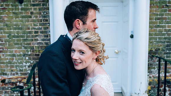 Bride and groom cuddling at their wedding at Swarling Manor